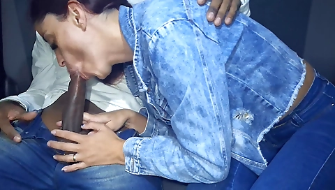 Sexy redhead in red dress is riding a cock in her car