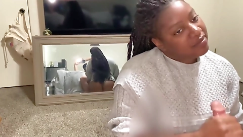 Ebony brunette gives a handjob to a white guy in her clothes